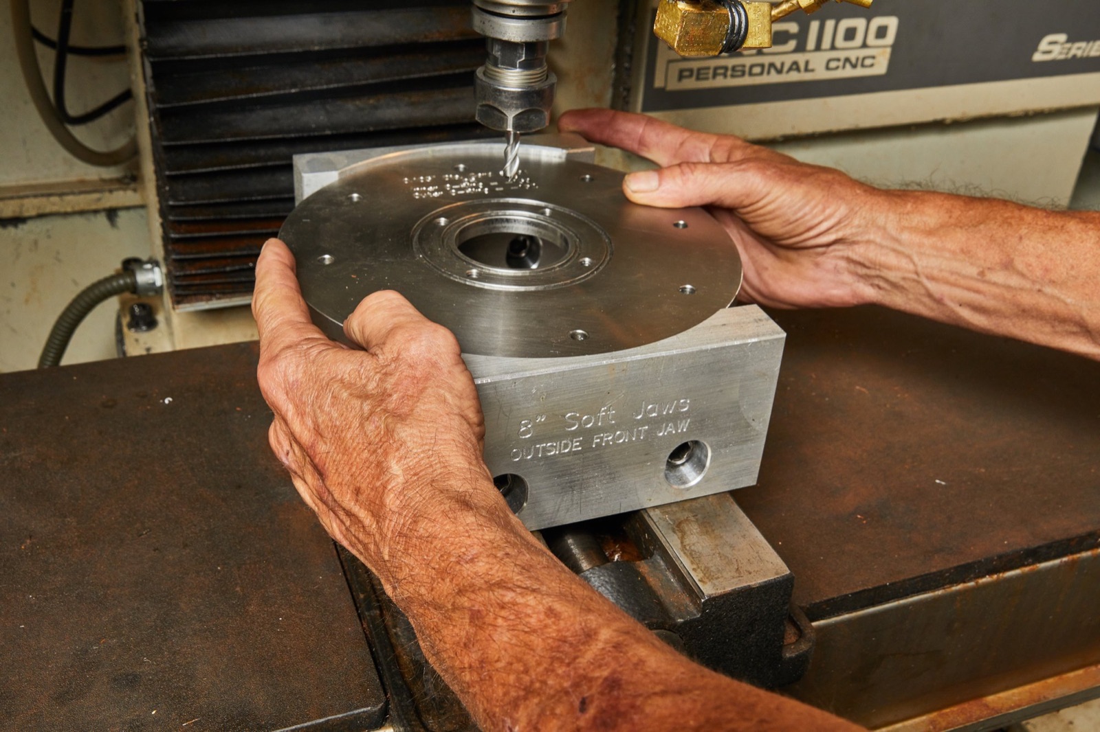 Steel die plate positioned under the CNC spindle